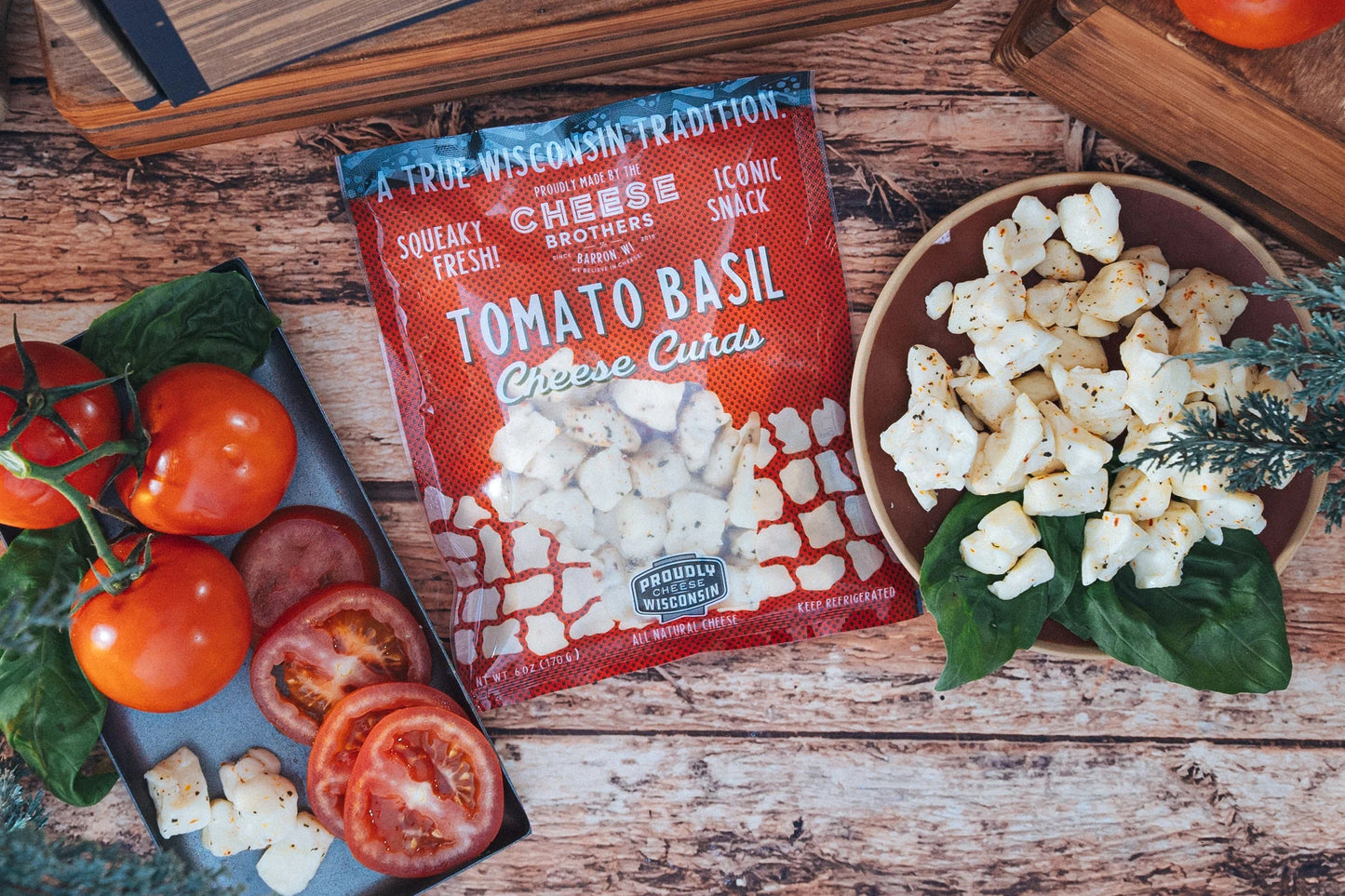 Fresh Tomato Basil Cheese Curds from Cheese Brothers, Inc. displayed in a bowl, showcasing vibrant tomatoes, basil, and creamy cheese curds.