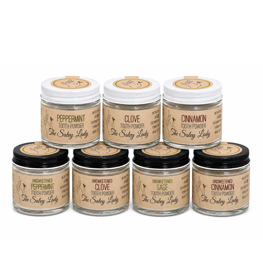 BuyNebraska.com fluoride-free tooth powder in 2 oz container with colorful packaging, available in multiple flavors for natural oral care.