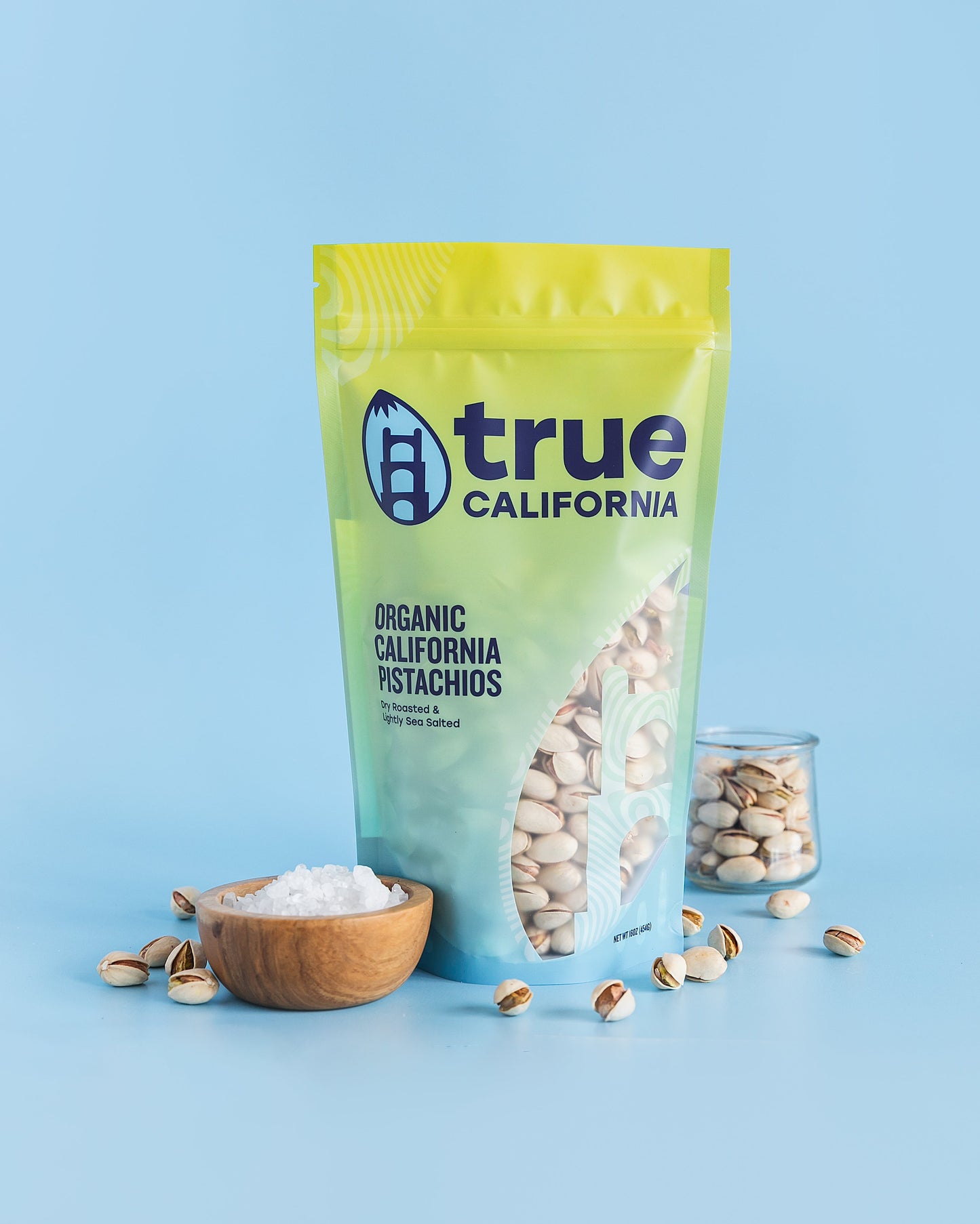Organic True California pistachios in a 1 lb bag, dry roasted and lightly salted with shells visible.