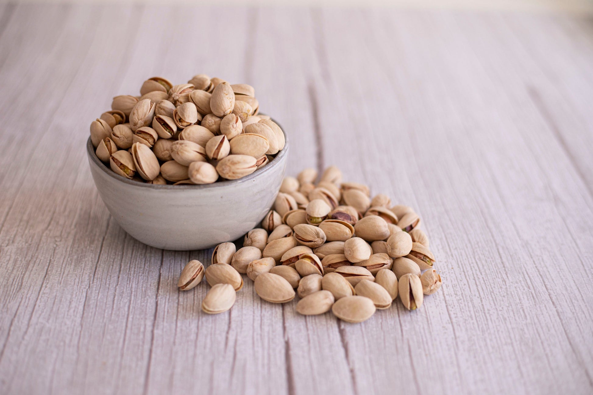 Organic True California pistachios in a 1 lb bag, natural and unsalted, showcasing green pistachios with shells.