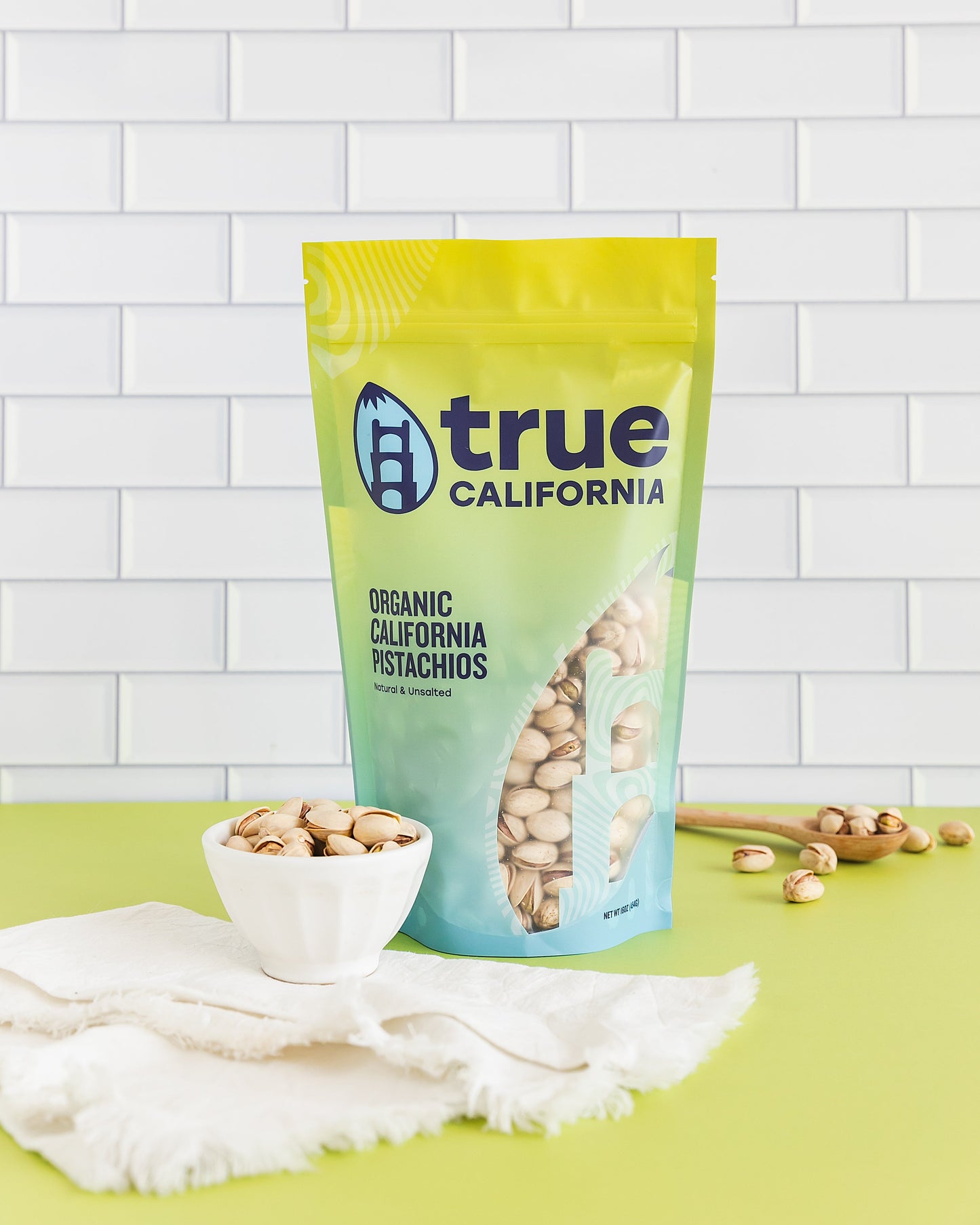 True California organic pistachios, natural and unsalted, shown in a close-up of a 1 lb bag of fresh pistachios.