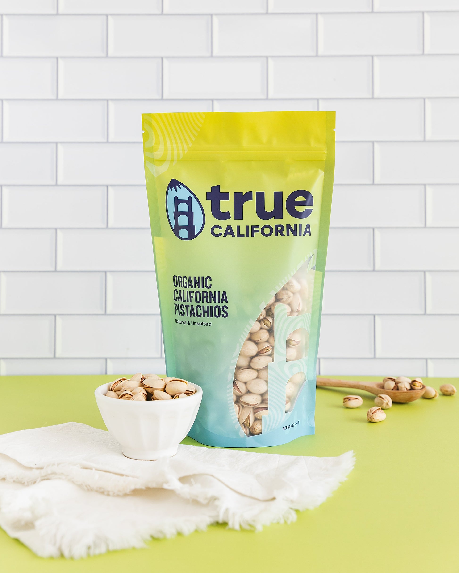 True California organic pistachios, natural and unsalted, shown in a close-up of a 1 lb bag of fresh pistachios.