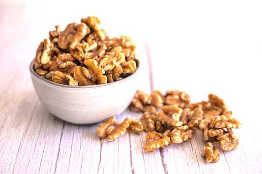 Organic Chandler walnuts from True California, close-up of 1 lb bag showing fresh, shelled walnuts in natural light.