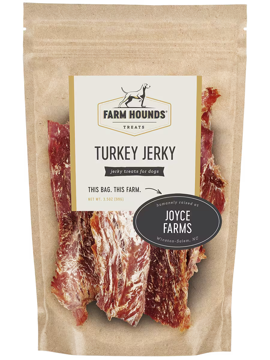 Farm Hounds turkey jerky, front view showing thin, natural slices of turkey jerky on a rustic background