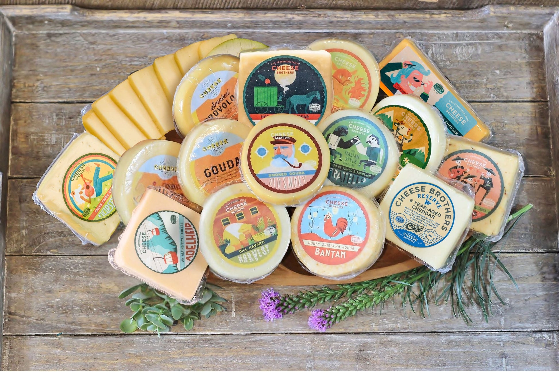 Assorted Wisconsin cheeses from Cheese Brothers, Inc. in a gift bundle with cheese varieties and packaging, ideal for gifting.