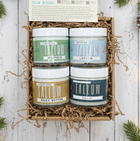 The Lady May Tallow Natural Beef Tallow Skincare Collection features lotion, butter, balm, and whipped tallow in a box with shredded paper, greenery, and an info card—a nourishing natural moisturizer set.