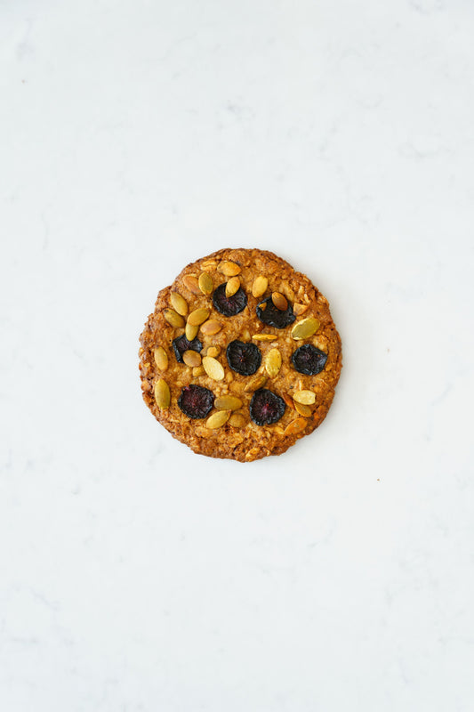 Three gluten-free vegan oat-cherry cookies from Heaven Gluten Free Bakery displayed on a plate.