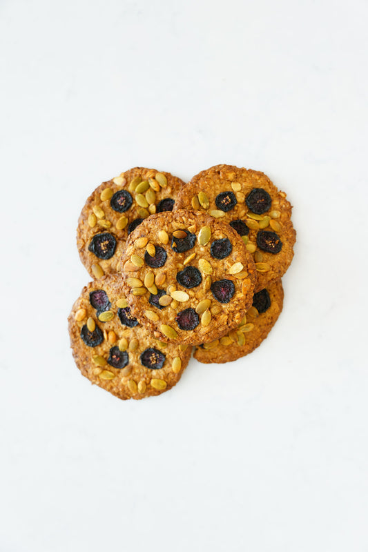 Three gluten-free vegan oat-cherry cookies from Heaven Gluten Free Bakery in a pastry pack on a white background.