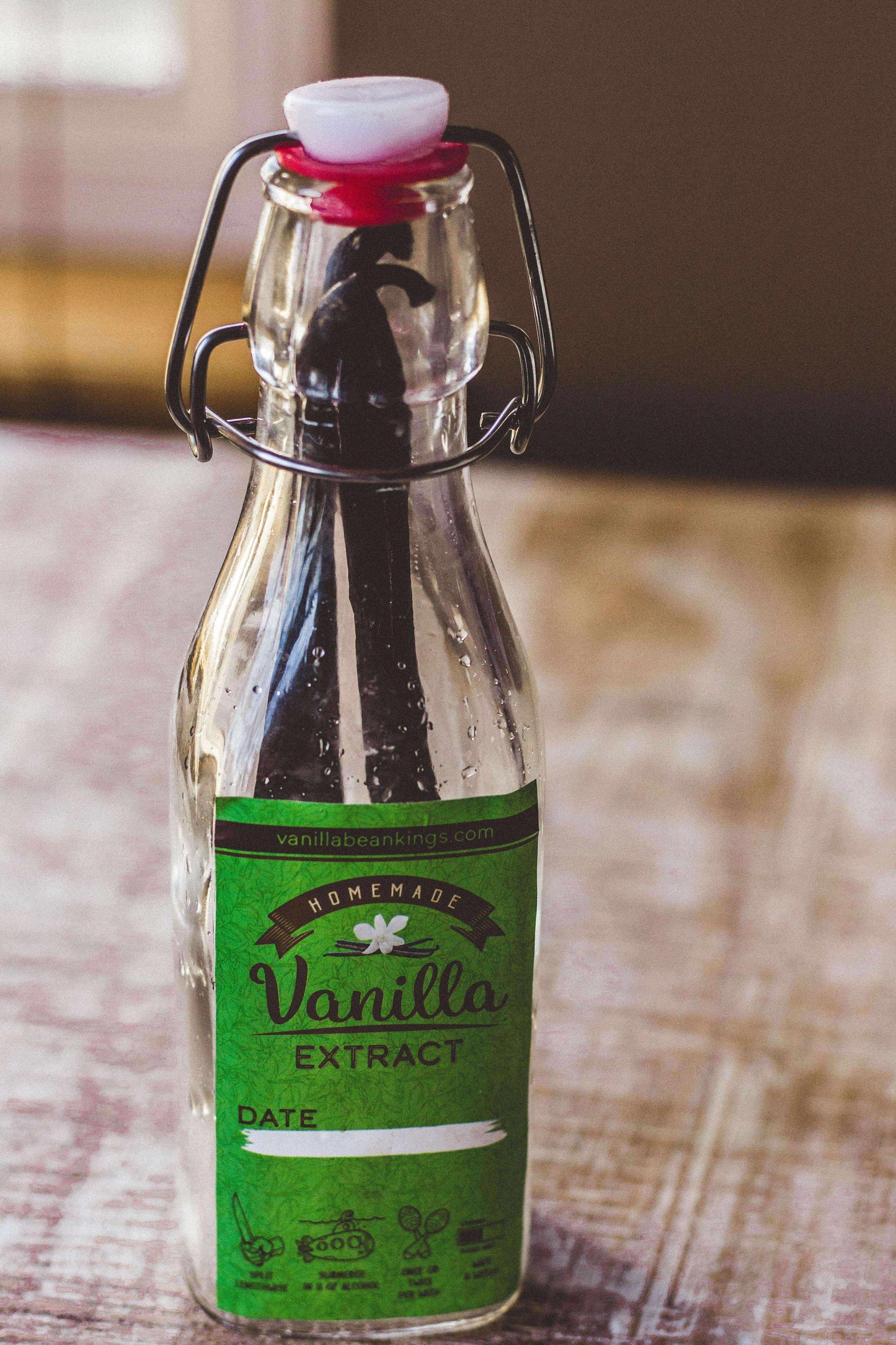 Homemade vanilla extract kit featuring organic Madagascar vanilla beans from Vanilla Bean Kings, with fresh vanilla beans displayed.