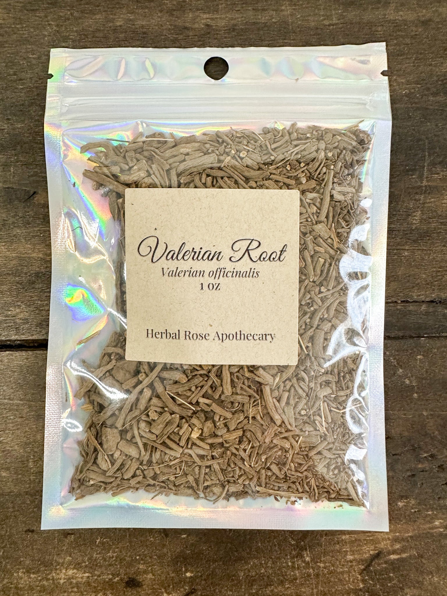 Dried valerian root herb in a 1oz package from HerbalRoseApothecary, showing earthy, twisted roots in natural light.