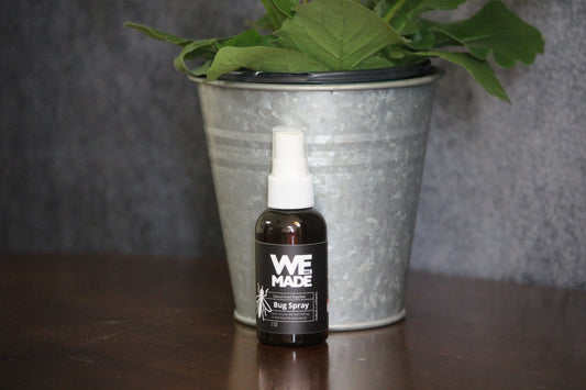WE Made bug spray in a 2 oz. bottle, featuring a spray nozzle and label with insect repellent ingredients.