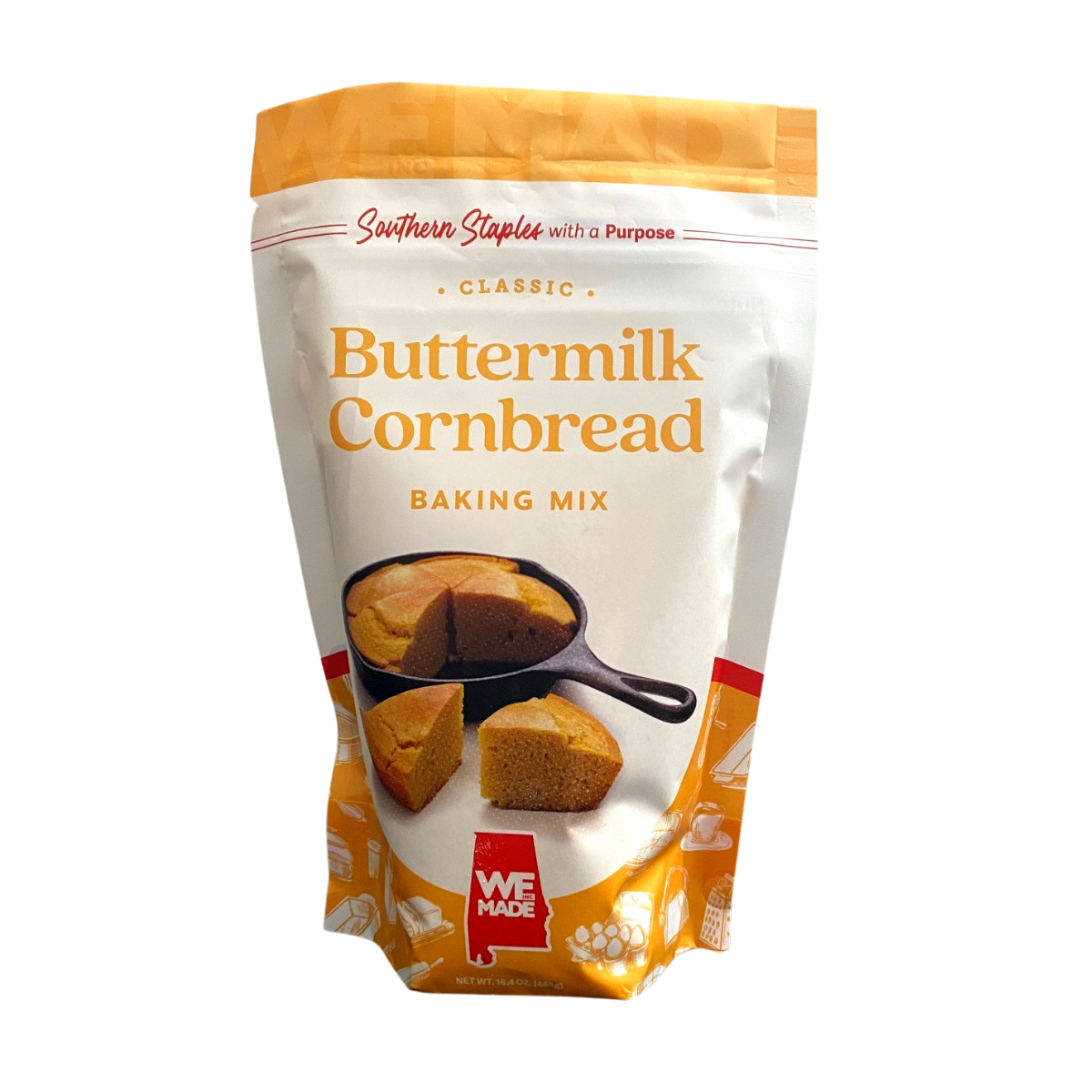 Box of WE Made Buttermilk Cornbread Mix with prepared batter in a bowl on a wooden surface.