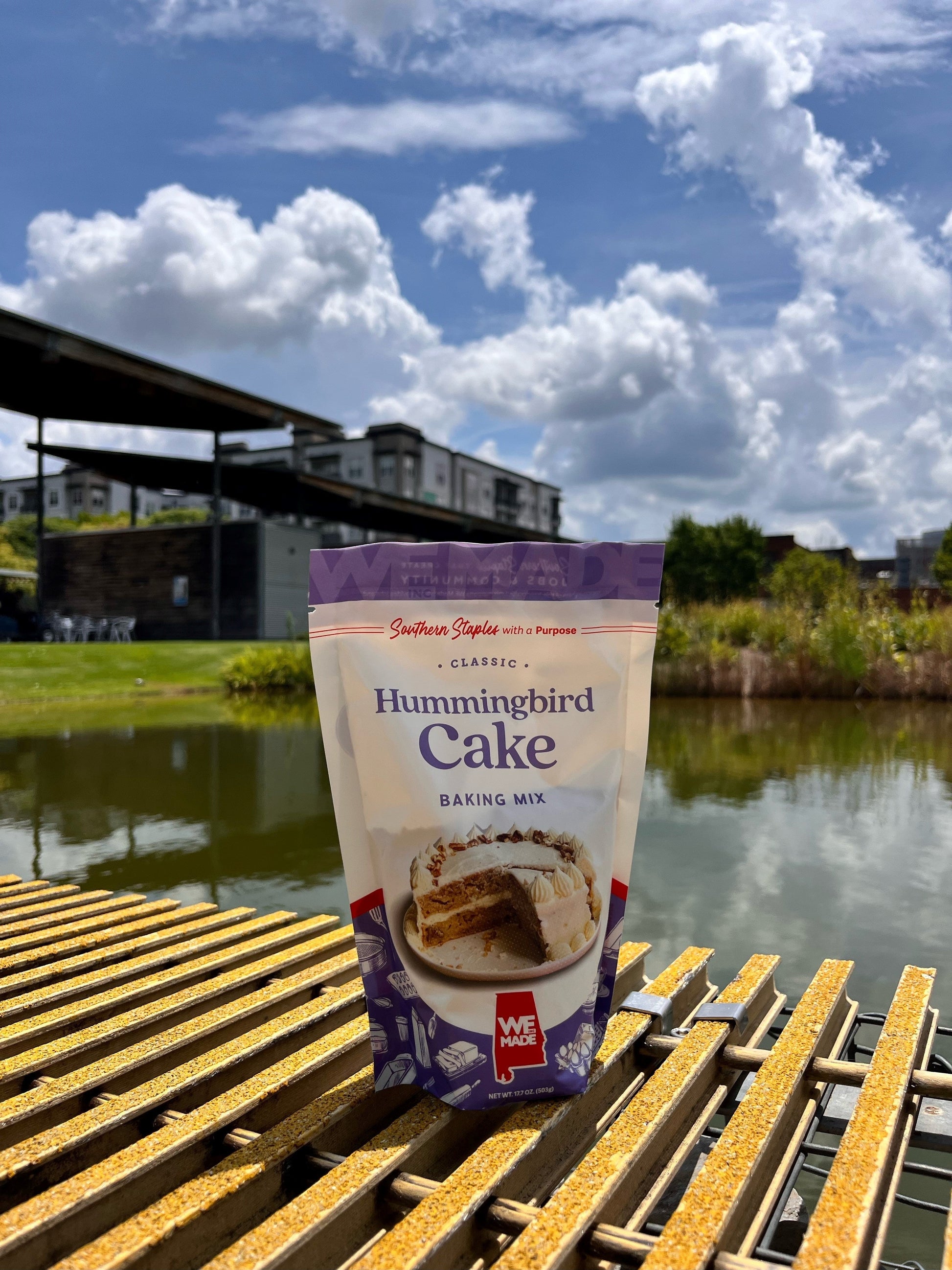 Hummingbird cake mix by WE Made featuring a ready-to-bake box with vibrant fruit and nut ingredients on the packaging.