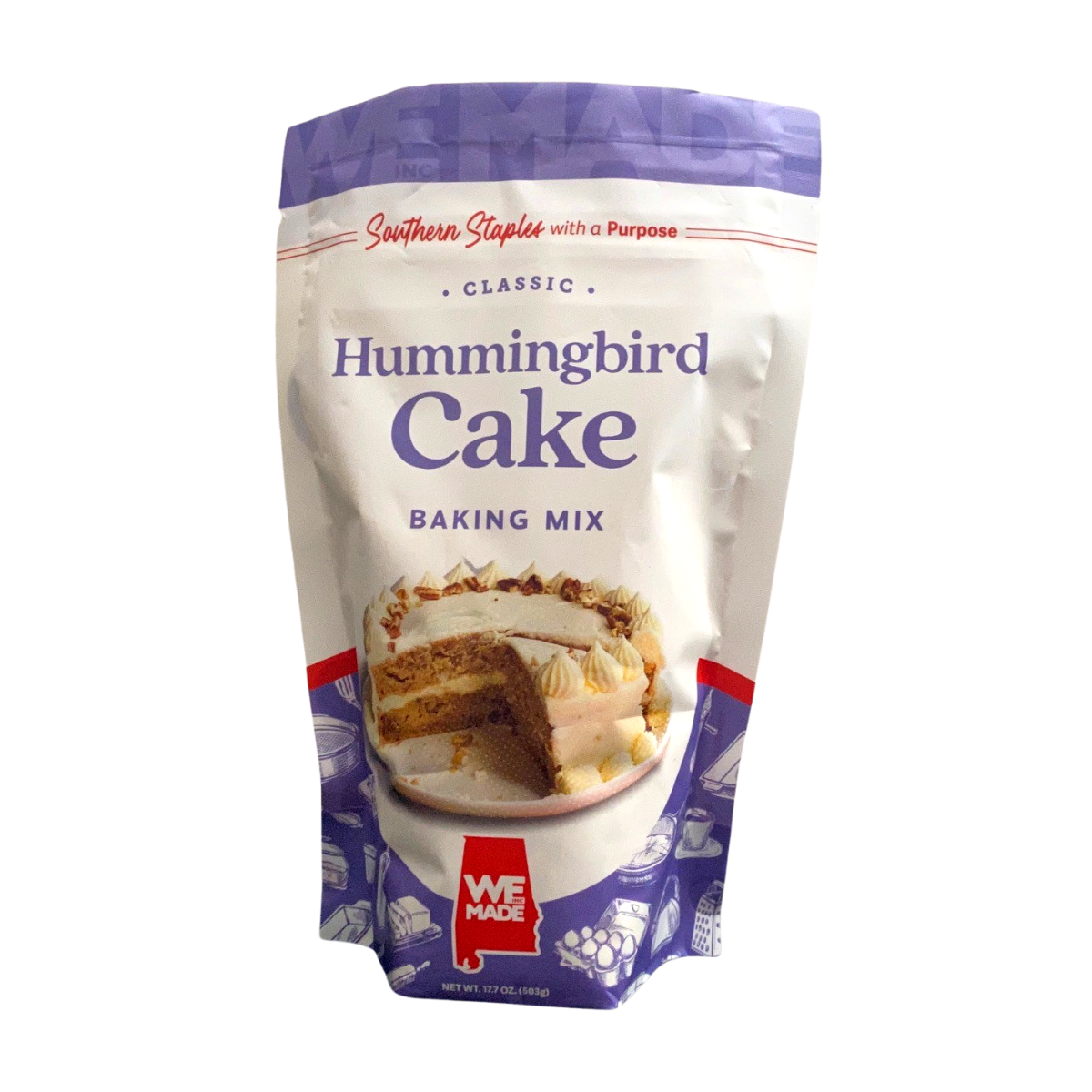 Box of WE Made Hummingbird Cake Mix with colorful packaging and images of the prepared cake on the front.