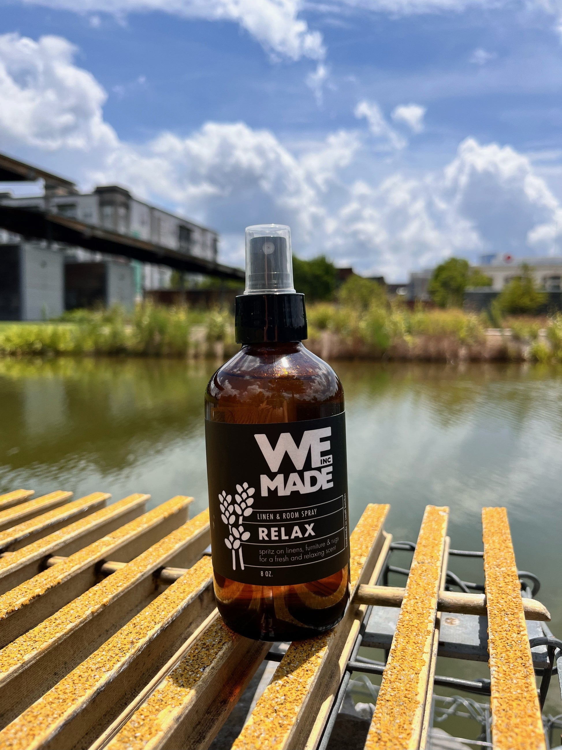 WE Made Relax Linen & Room Spray bottle with a minimalist label, designed to freshen and add a calming aroma to spaces.
