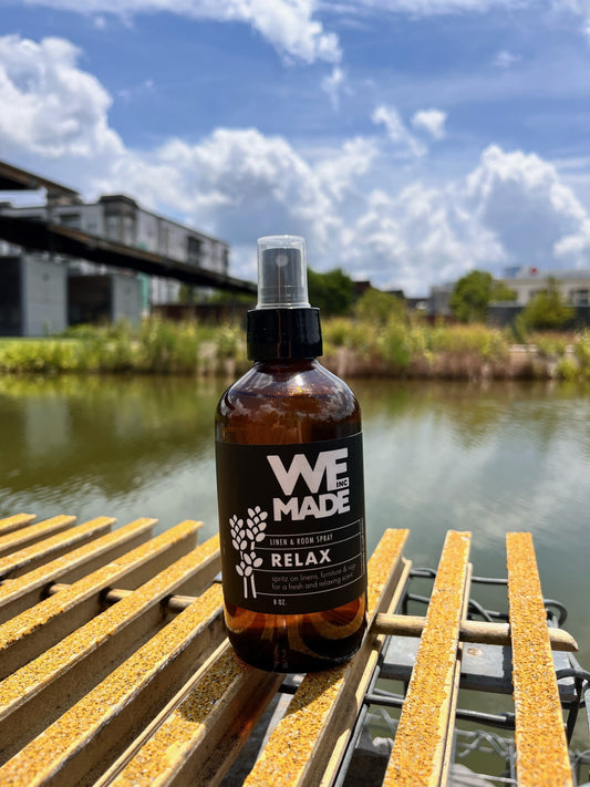WE Made Relax Linen & Room Spray bottle with a minimalist label, designed to freshen and add a calming aroma to spaces.