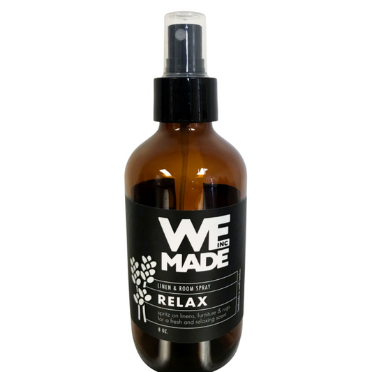 WE Made Relax Linen & Room Spray bottle with labels, showcasing a calming scent for freshening linens and rooms.