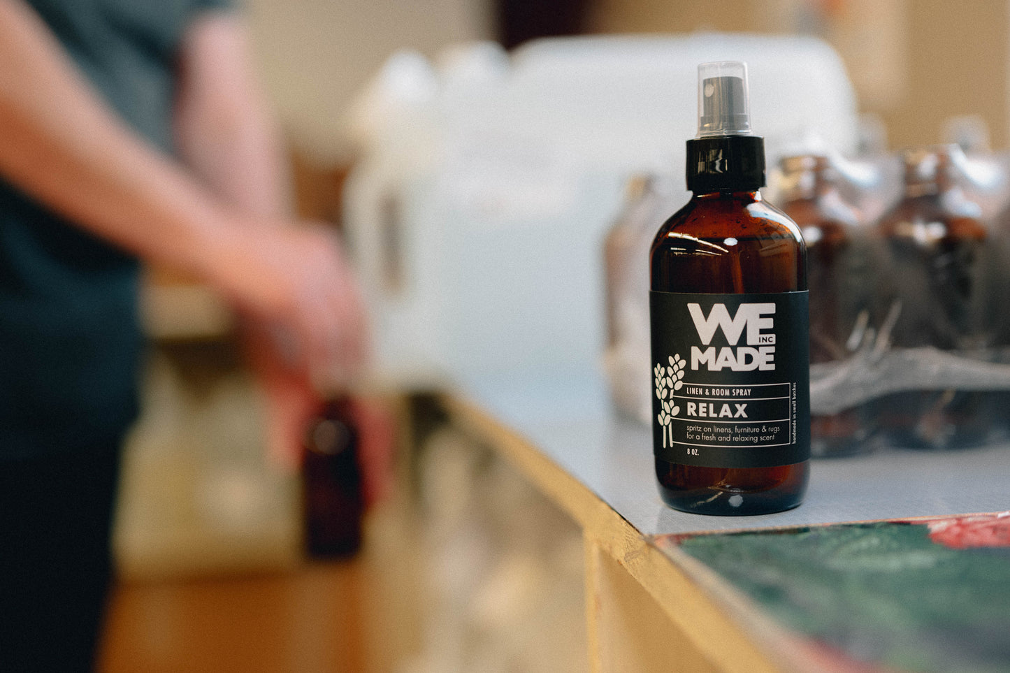 WE Made Relax Linen & Room Spray bottle with label, showcasing its calming linen scent and elegant packaging.