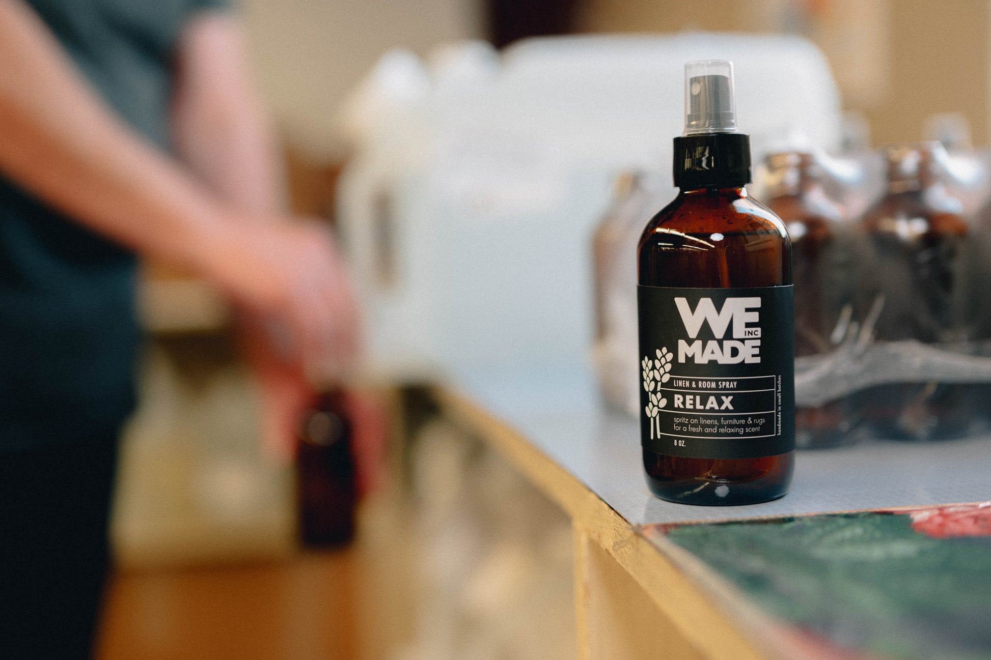 WE Made Relax Linen & Room Spray bottle with label, showcasing its calming linen scent and elegant packaging.
