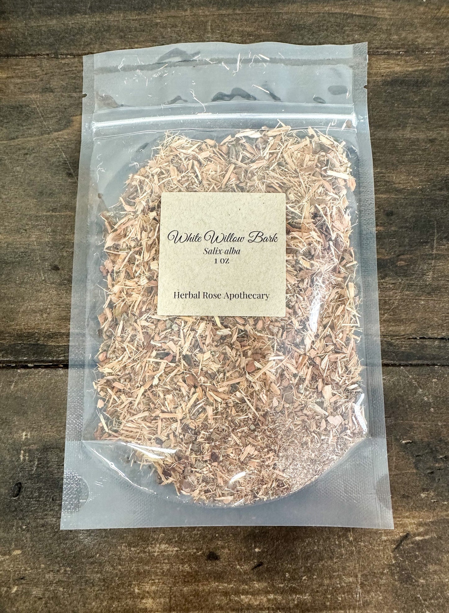 Dried white willow bark herb in a 1-ounce package from Herbal Rose Apothecary, showing the textured, natural herb pieces.