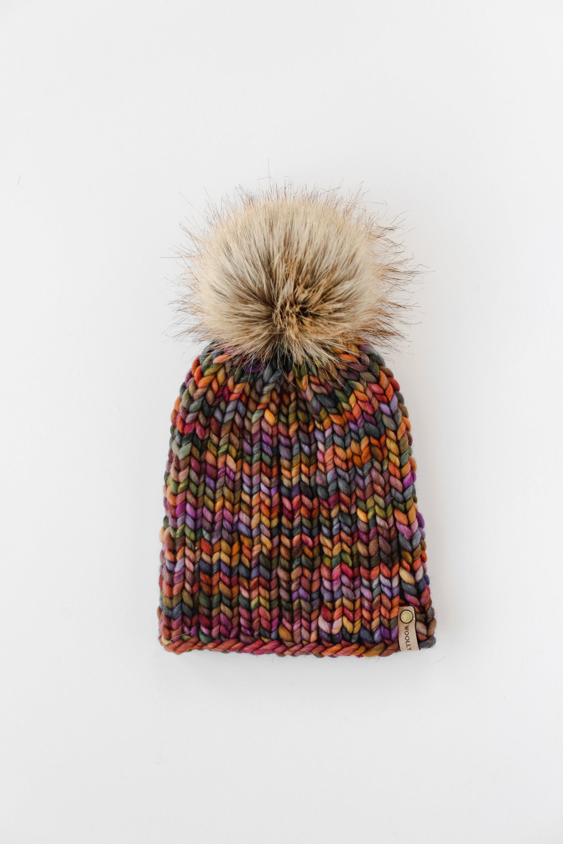 Brown multi-color merino wool knit hat with ribbed texture and faux fur pom-pom from Woolly Bear Knits.