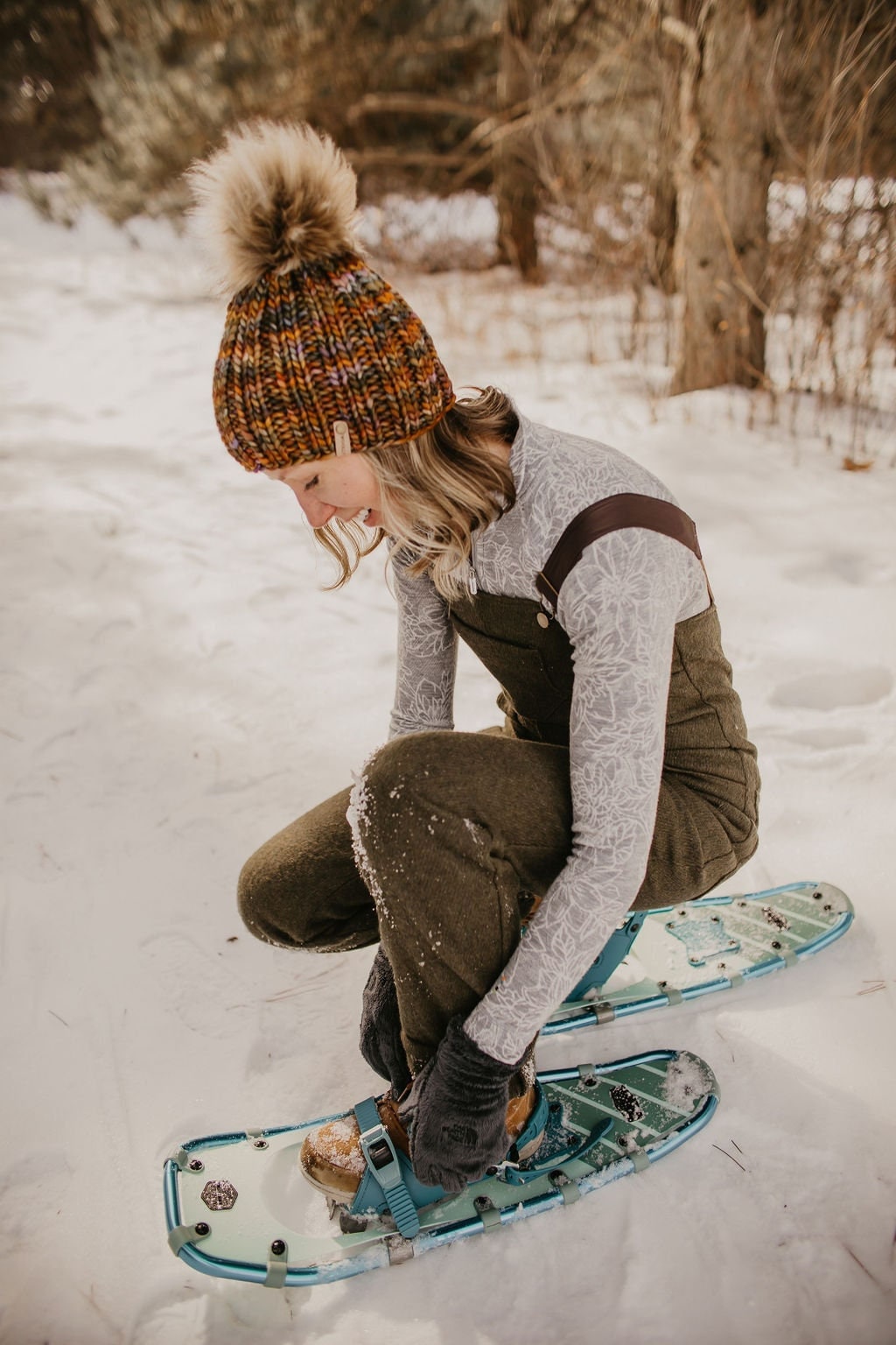Brown multi-color merino wool ribbed knit hat with faux fur pom pom by Woolly Bear Knits, warm and cozy winter accessory.