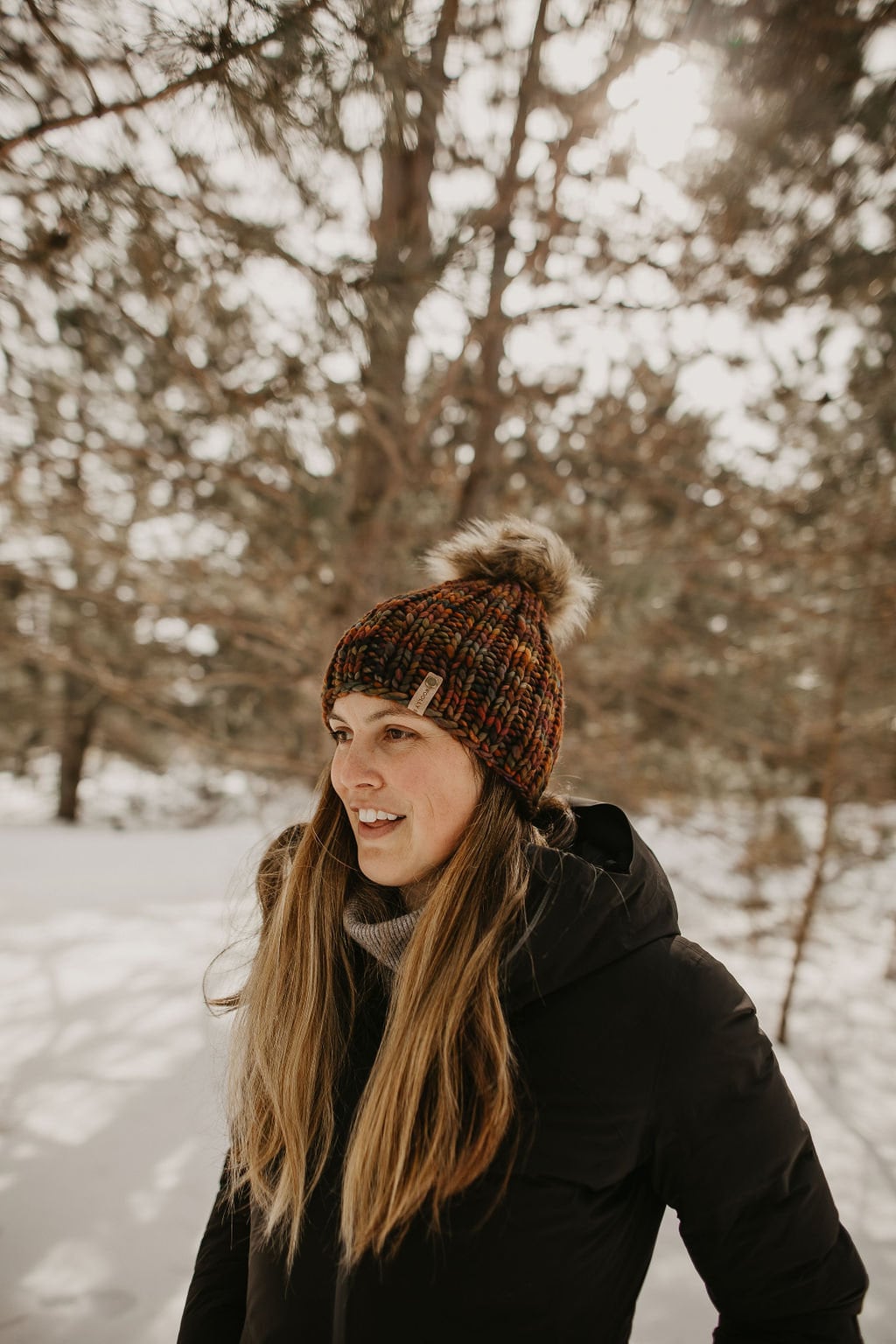 Brown multi-color merino wool knit hat with ribbed texture and faux fur pom pom from Woolly Bear Knits.