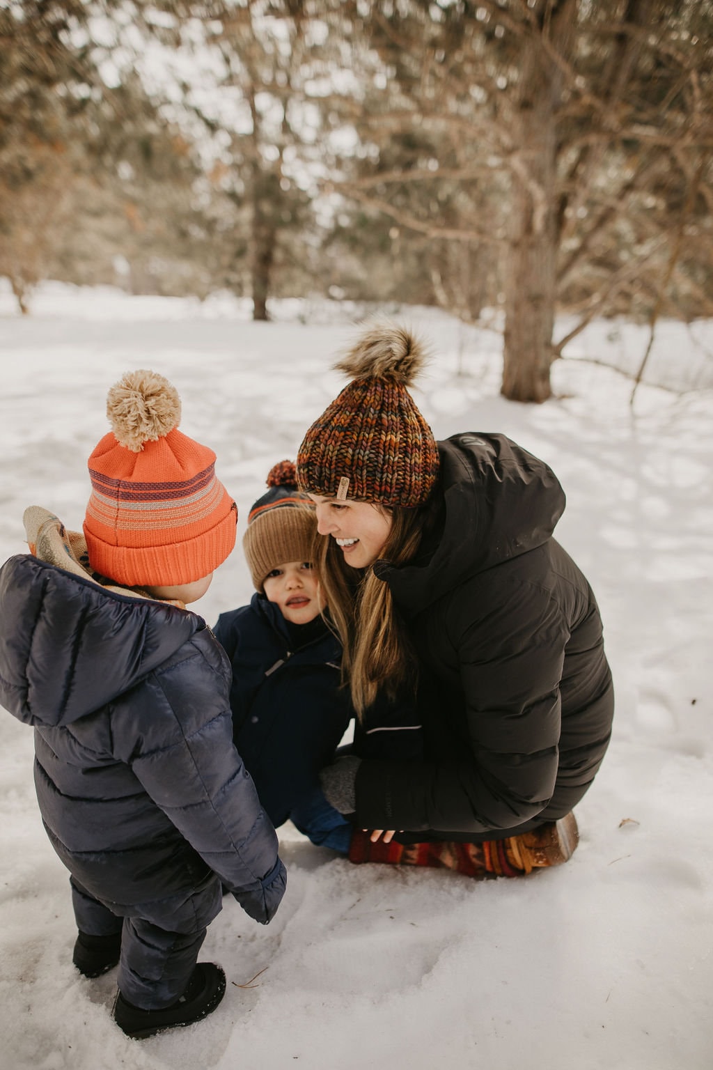 Brown multi-color Merino Wool Ribbed Knit Hat with faux fur pom pom from Woolly Bear Knits, featuring cozy ribbed texture and soft faux fur.