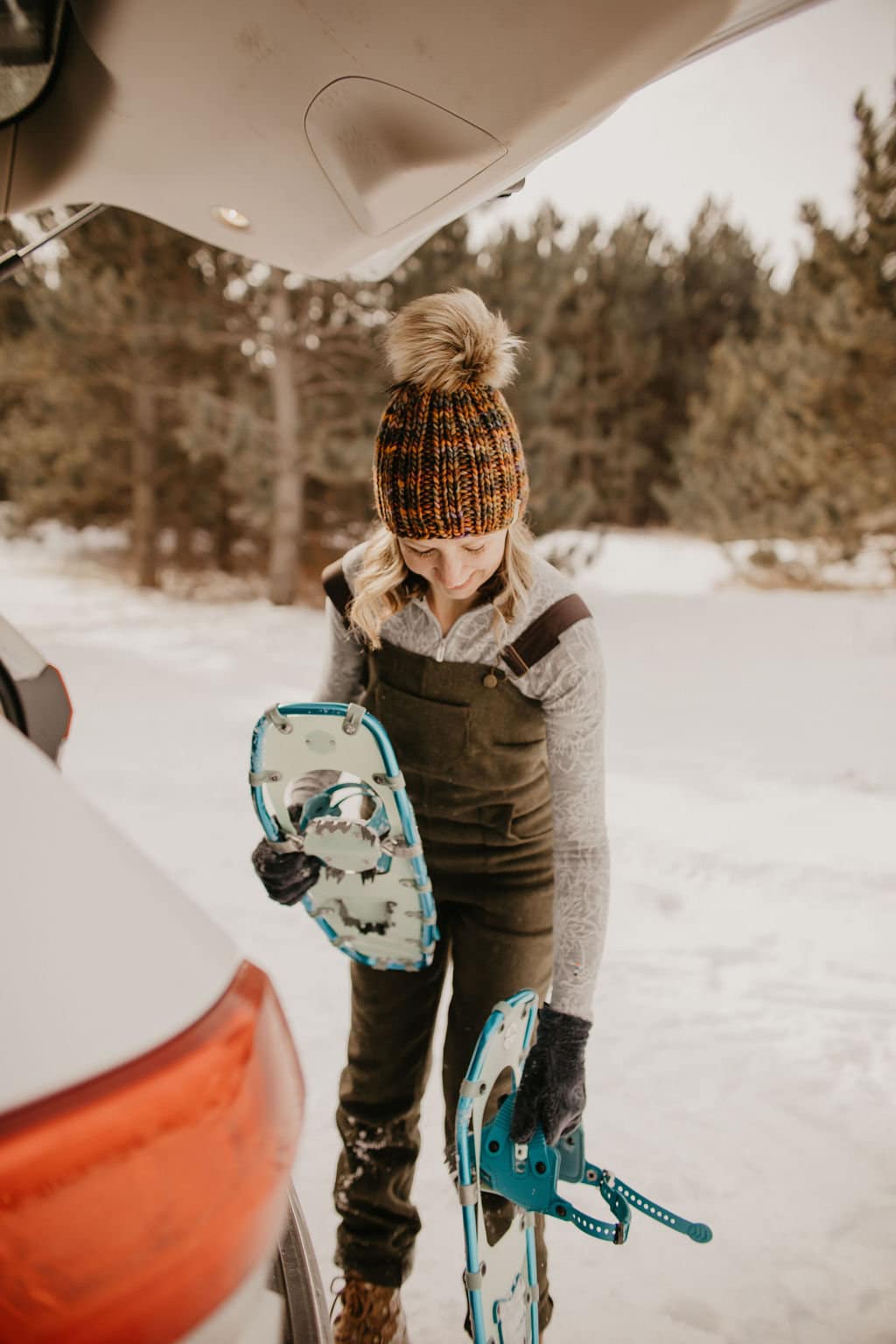 Brown multi-color Merino Wool Ribbed Knit Hat with faux fur pom pom from Woolly Bear Knits, featuring cozy, textured knit and playful pom.