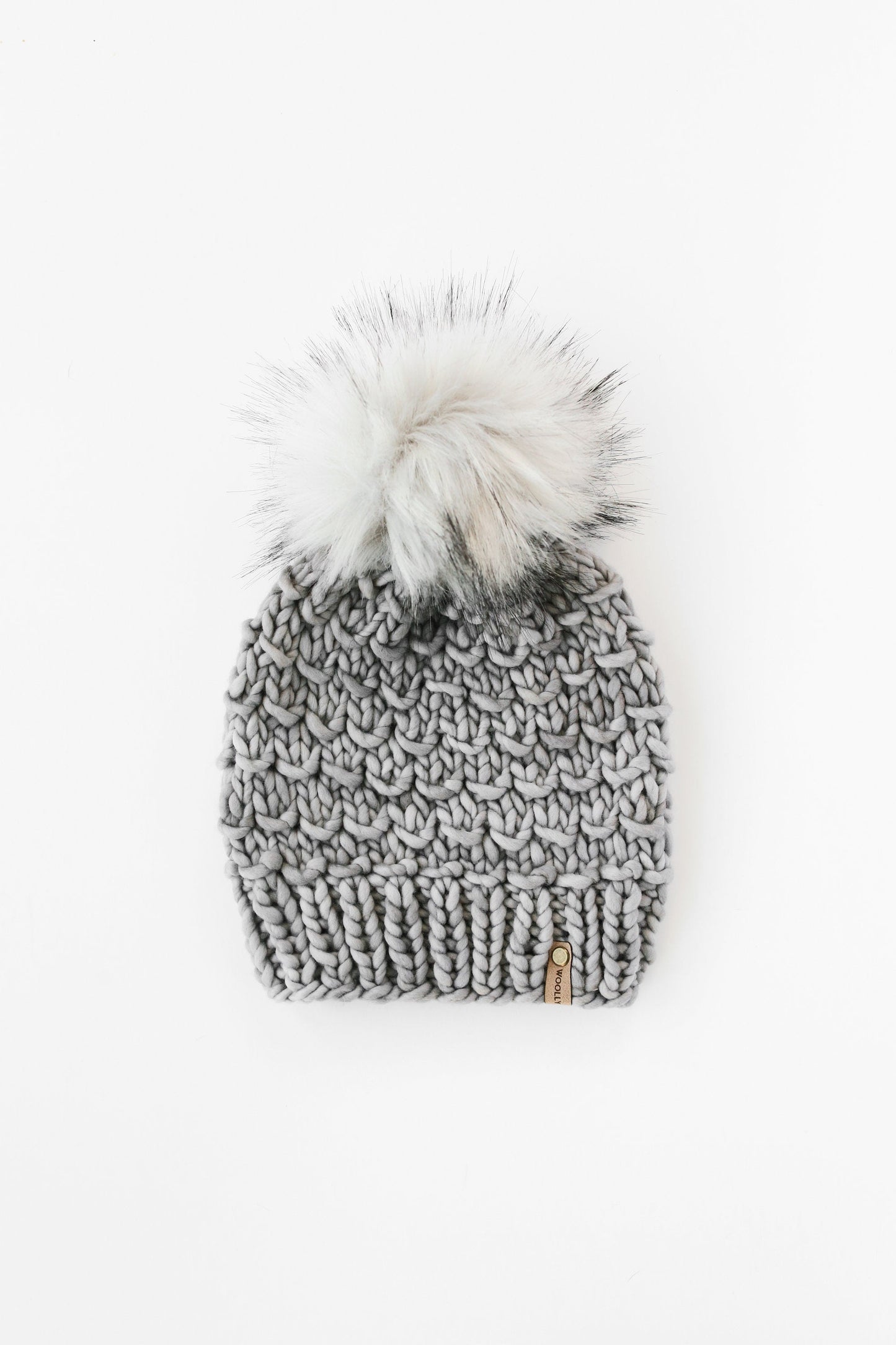 Gray Merino Wool Knit Hat with Faux Fur Pom Pom by Woolly Bear Knits, featuring a cozy woolen design and fluffy pom pom accessory.