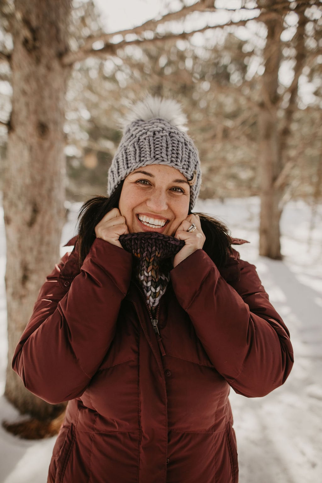 Gray Merino Wool Knit Hat with faux fur pom-pom from Woolly Bear Knits, showing the cozy wool texture and fluffy pom on top.