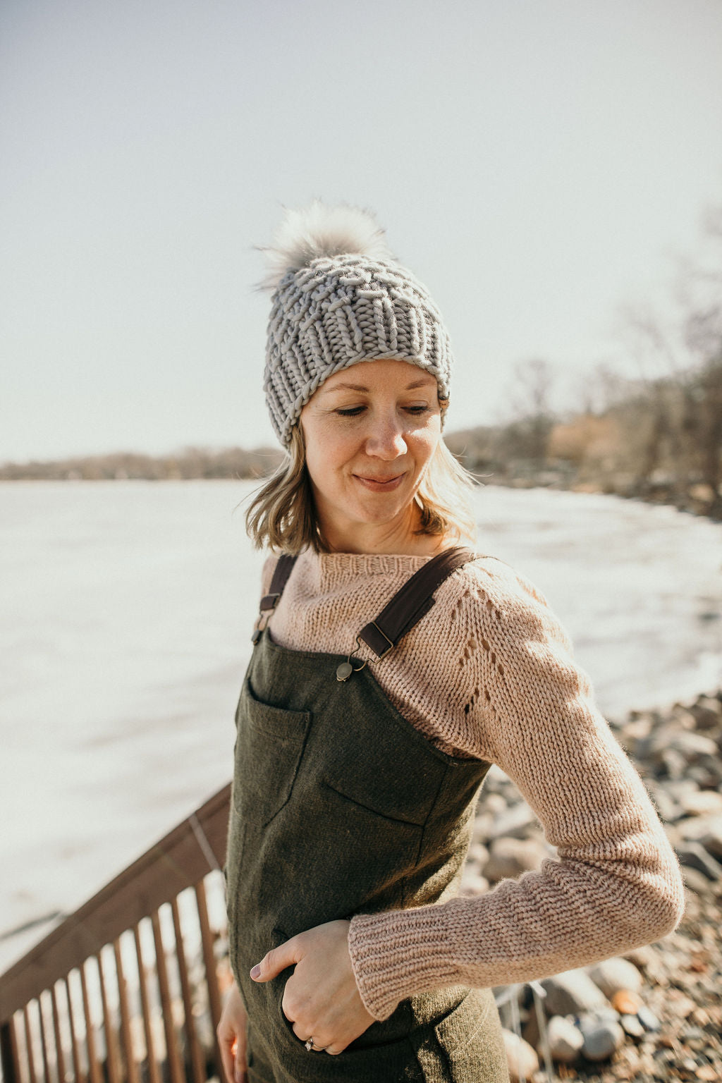 Gray Merino Wool Knit Hat with Faux Fur Pom Pom by Woolly Bear Knits, featuring a cozy woolen texture and fluffy pom on top.