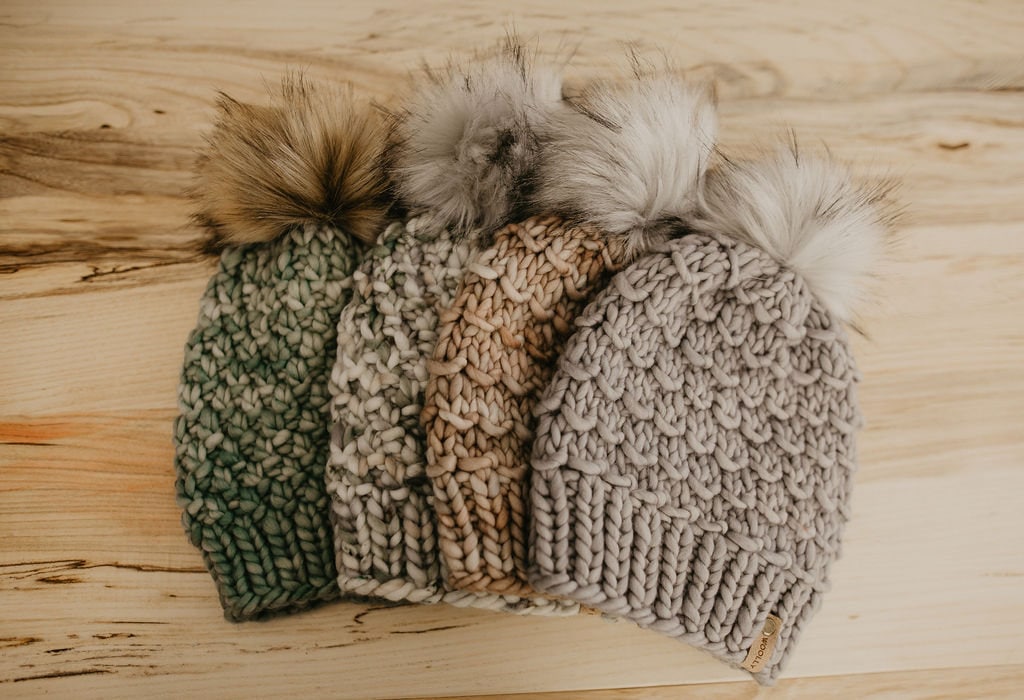 Gray Merino Wool Knit Hat with Faux Fur Pom Pom by Woolly Bear Knits, showcasing a cozy wool hat with playful pom pom detail.