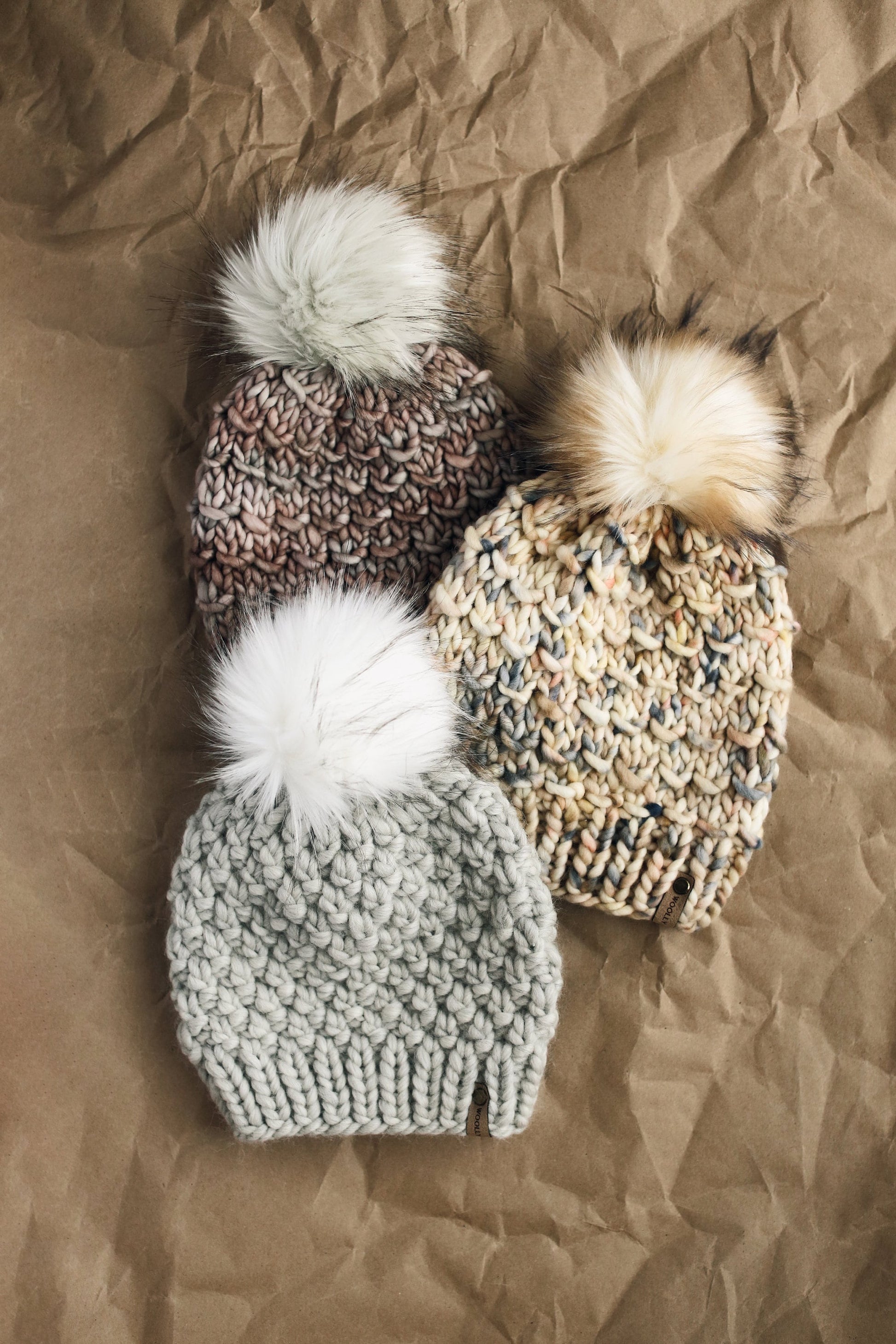 Pearl gray merino wool knit hat with faux fur pom pom from Woolly Bear Knits, showcasing soft, cozy winter headwear.