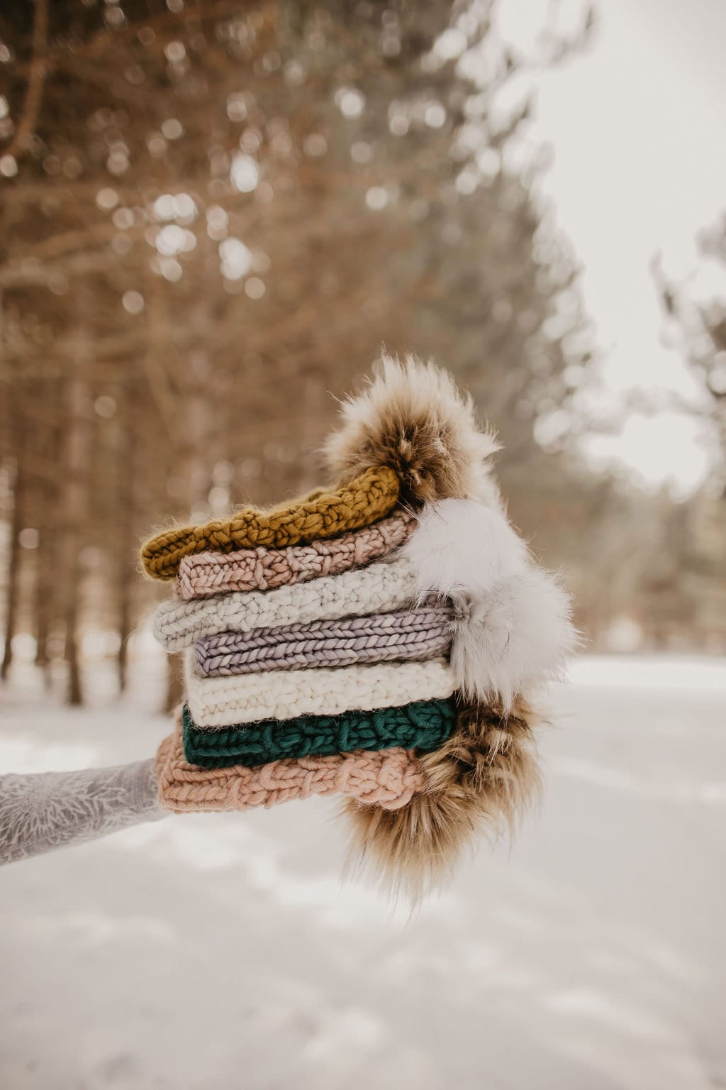 Ivory Peruvian wool knit hat with faux fur pom pom by Woolly Bear Knits, cozy and warm winter accessory with textured knit pattern.