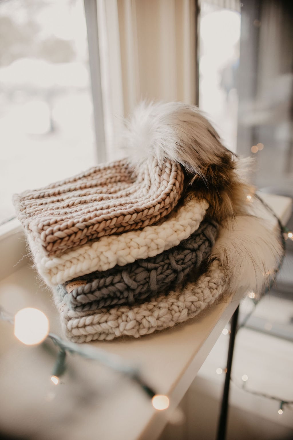 Ivory Peruvian wool knit hat with faux fur pom pom by Woolly Bear Knits, featuring warm, textured Peruvian wool and plush pom accent.
