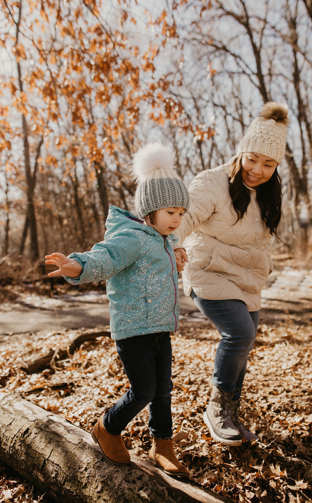 Ivory Peruvian wool knit hat with faux fur pom pom by Woolly Bear Knits, featuring a cozy, textured design and fluffy pom on top.