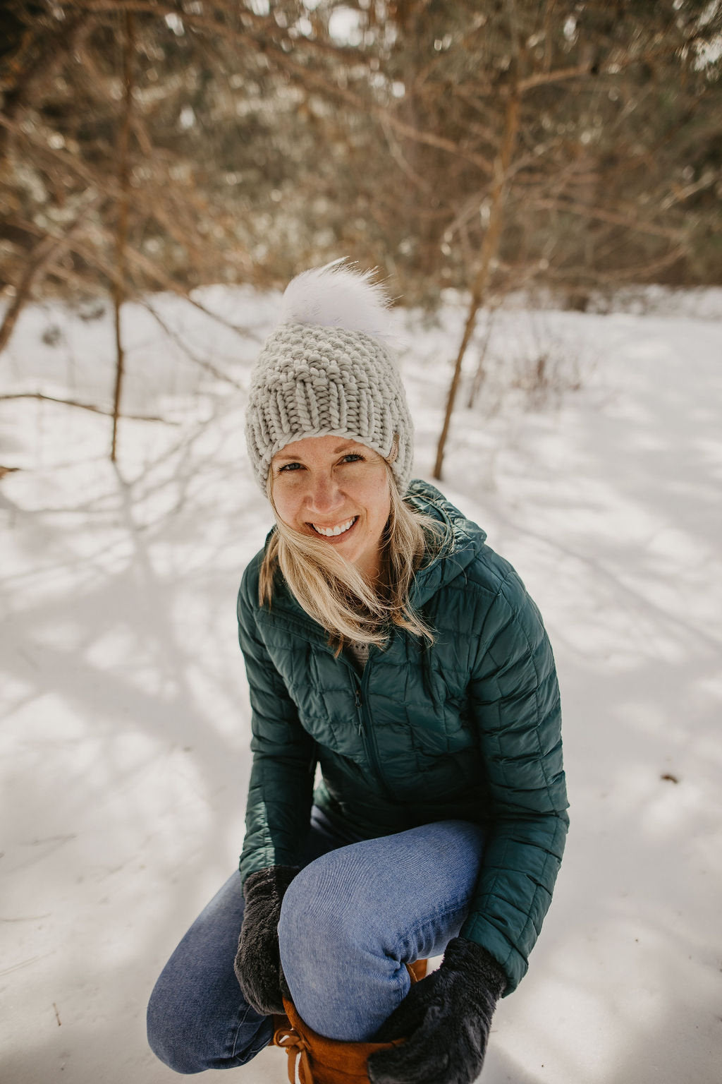 Light gray Peruvian wool knit hat with faux fur pom-pom by Woolly Bear Knits, warm and cozy winter accessory.