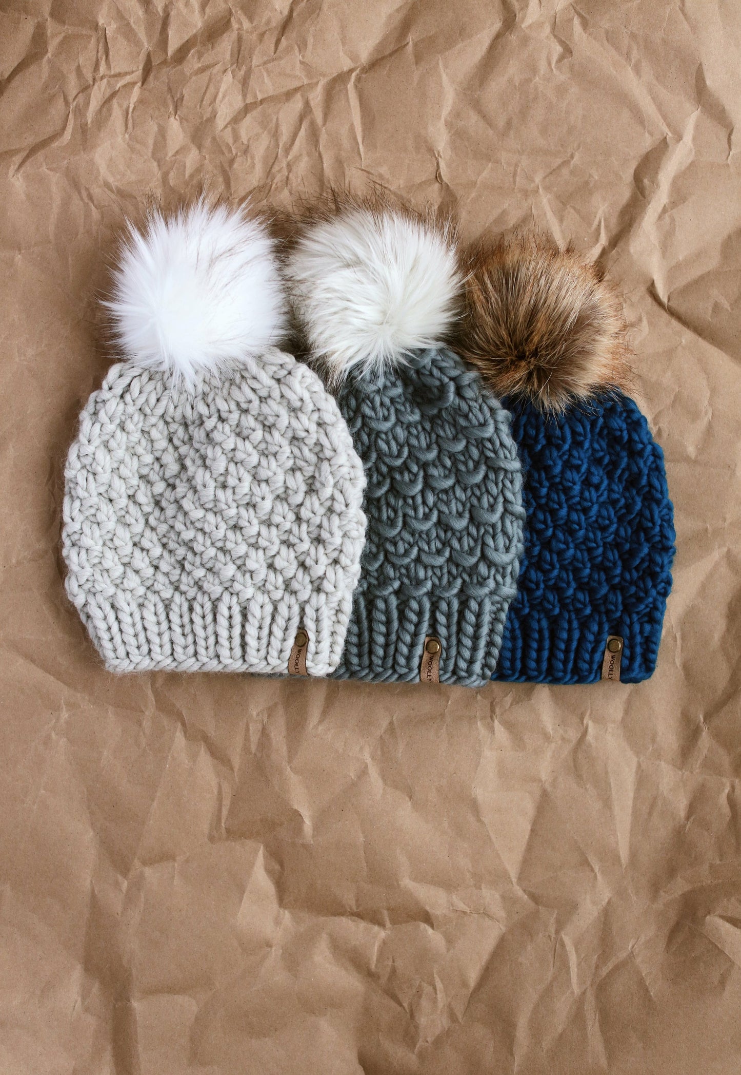 Light gray Peruvian wool knit hat with faux fur pom pom from Woolly Bear Knits, cozy and stylish winter accessory.