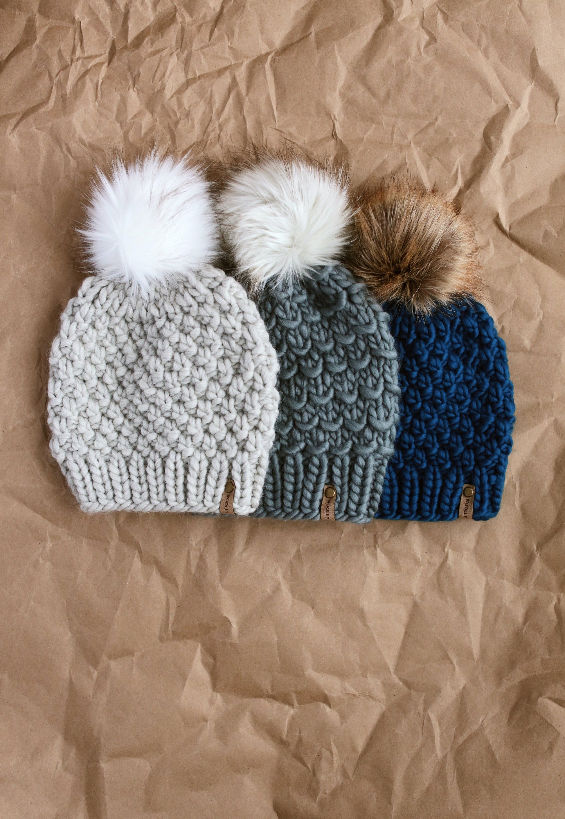 Light gray Peruvian wool knit hat with faux fur pom pom from Woolly Bear Knits, cozy and stylish winter accessory.