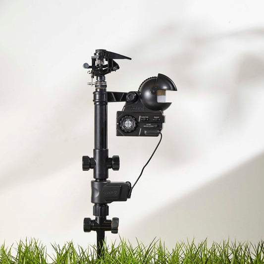 Orbit Irrigation Yard Enforcer Motion-Activated Sprinkler 62100 attached to garden hose, ready to deter pests with spray activation.