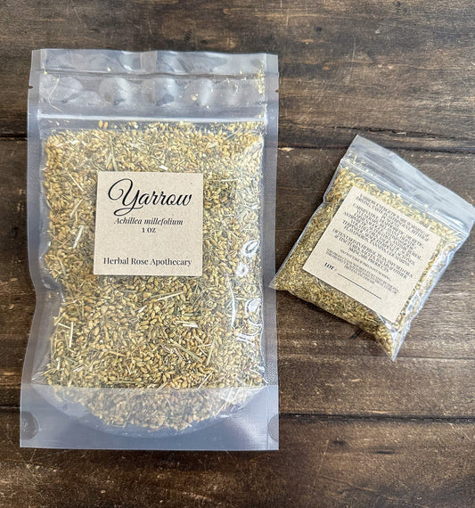 Dried yarrow herbs from HerbalRoseApothecary, with green leaves and white flowers in a rustic jar.