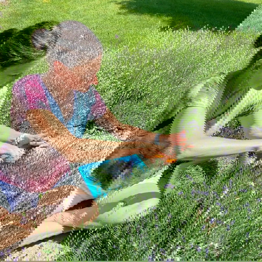 A distorted image shows people on grass with vibrant digital glitches, evoking the soothing relief that Your Only Earth’s Lavender Balm provides for dry skin.