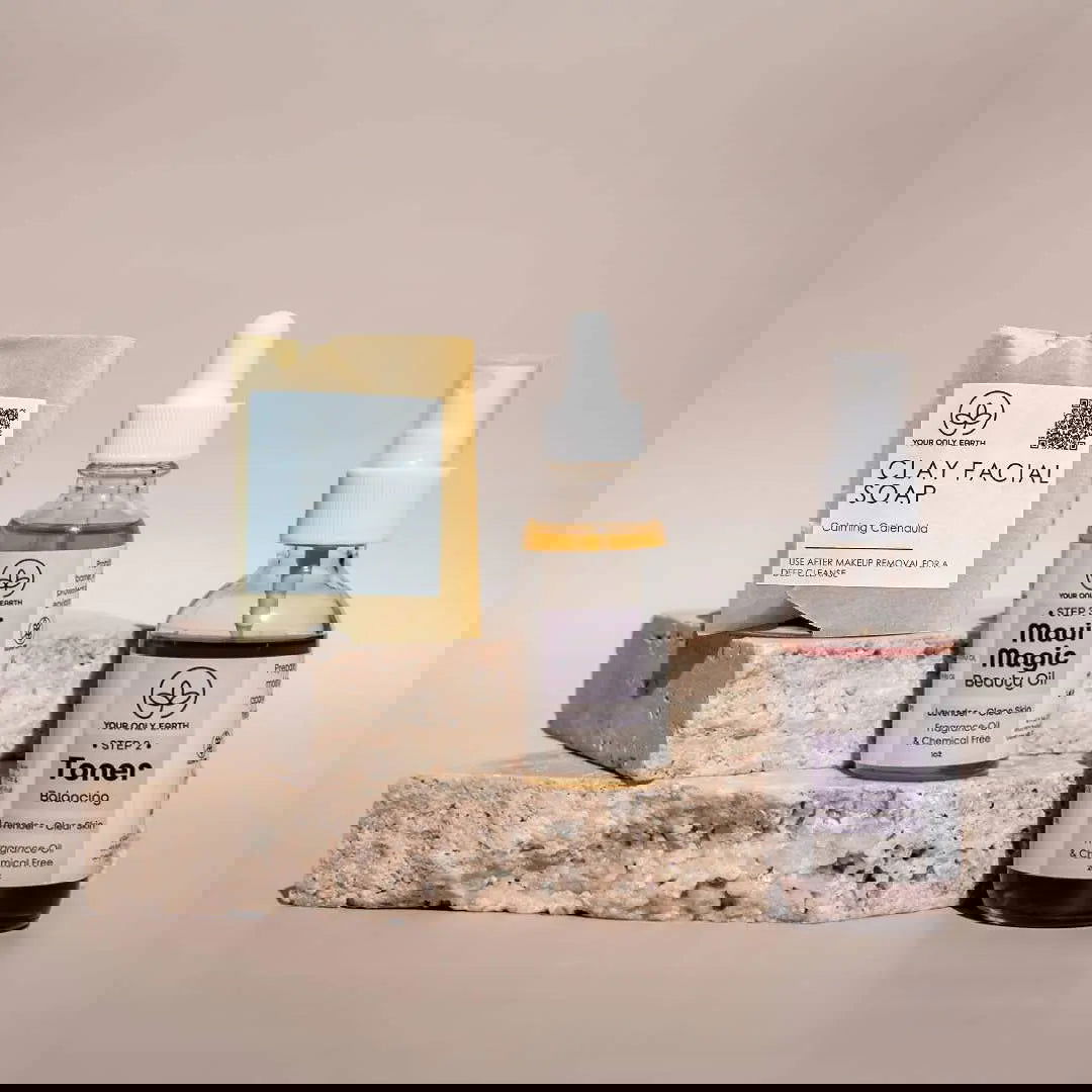 The Dewy Skincare Set by Your Only Earth rests on a neutral surface, with metallic tubes labeled with plant extracts and pastel geometric overlays, conveying a modern, sustainable skincare aesthetic.