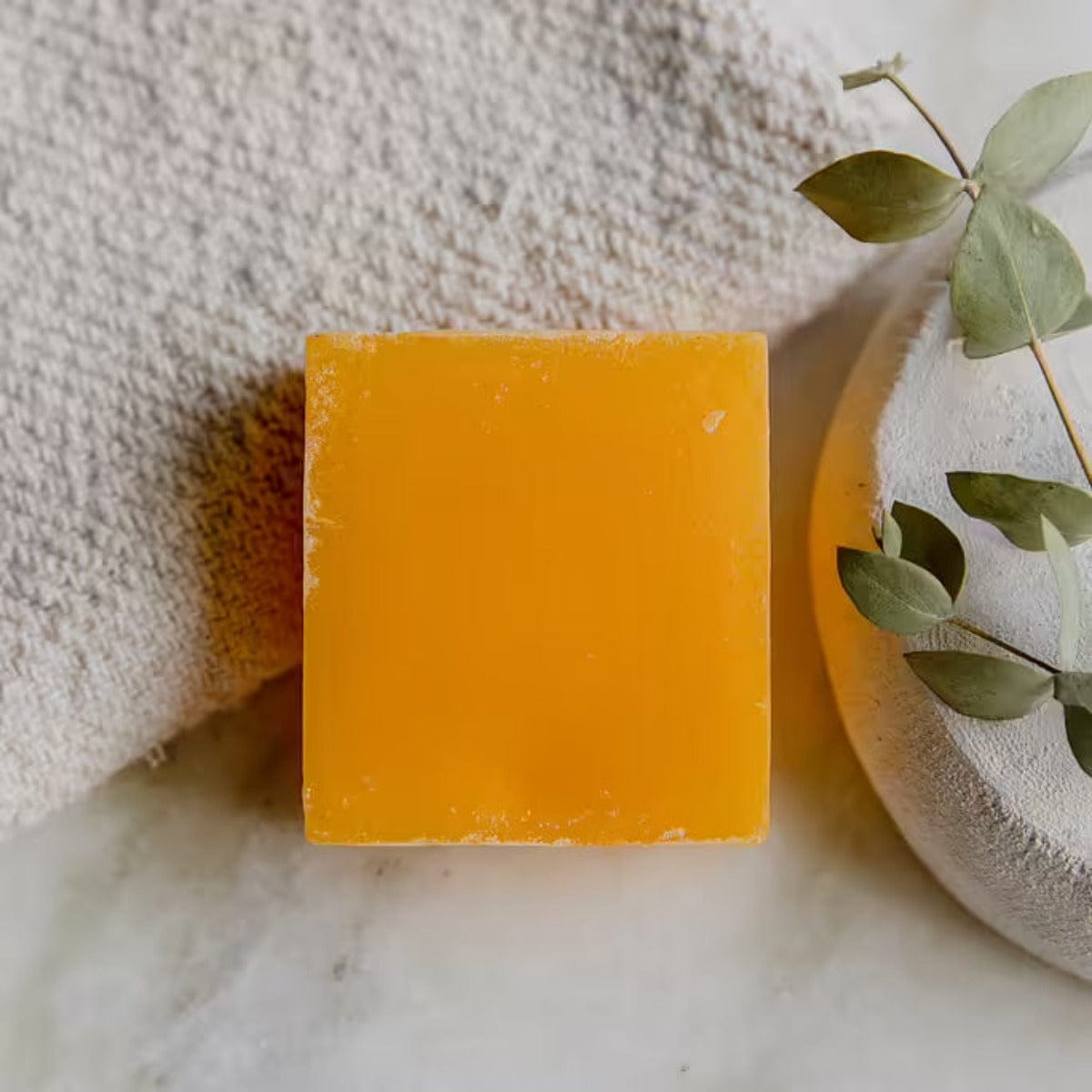 Zero Waste Glycerin Soap Bar by Suds & Eco, 4.5oz, showing a clear glycerin soap bar with a natural, sunlit background.