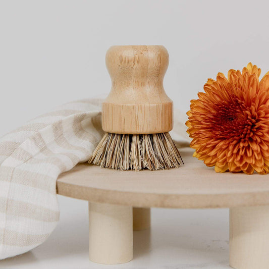 Eco-friendly bamboo pot scrubber, plastic-free and compostable household cleaning brush for eco-conscious kitchen use.