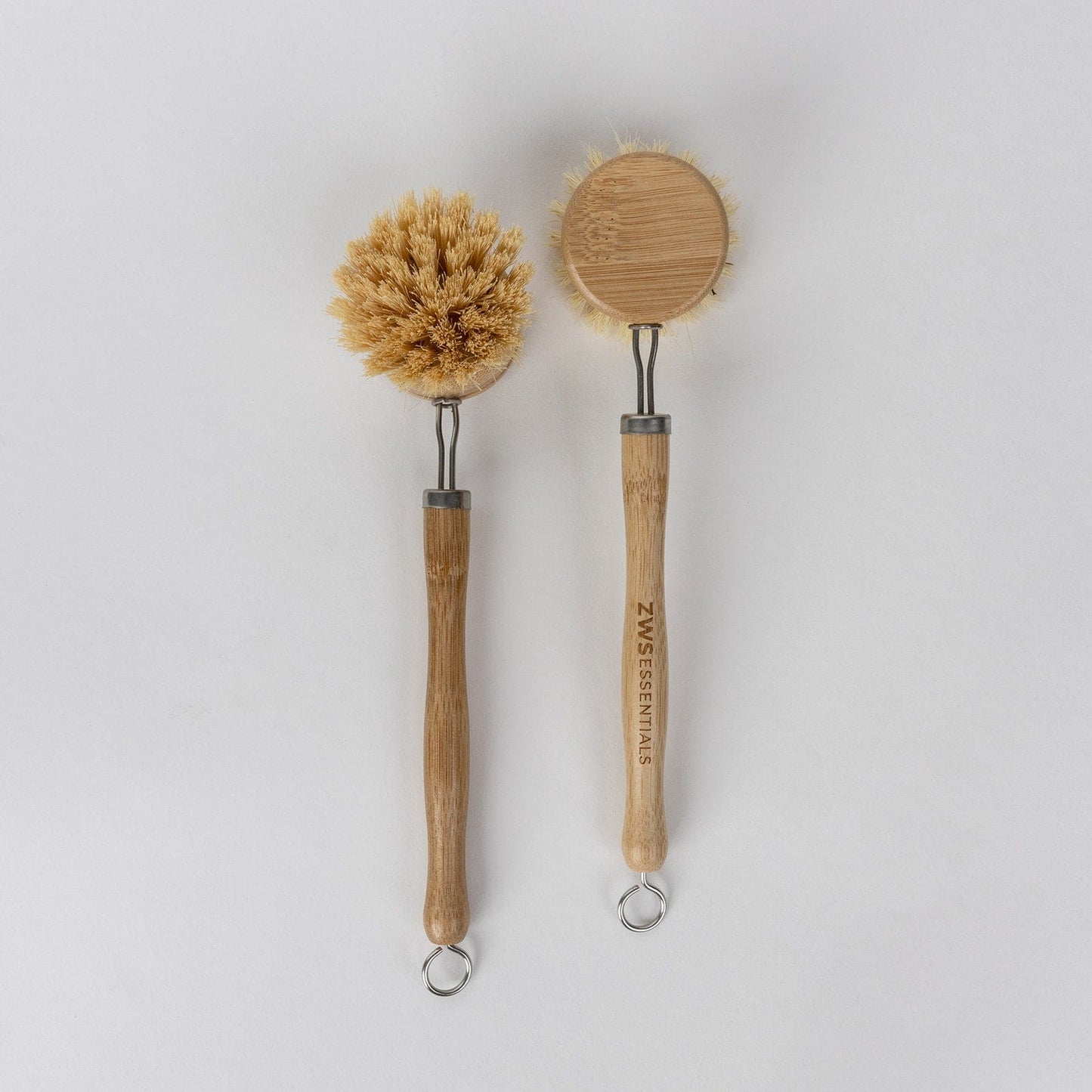 Long handle dish scrub brush from ZeroWasteStore.com with a sturdy head, ideal for cleaning dishes and kitchenware.