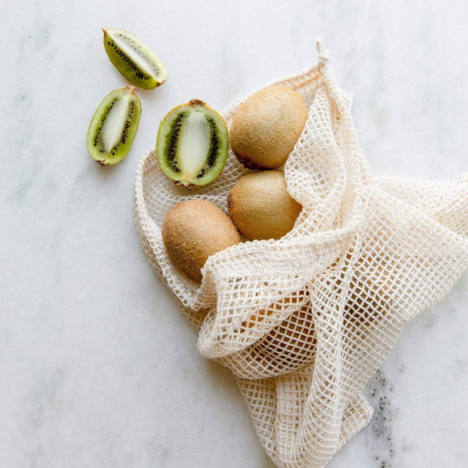 Natural mesh produce bag in multiple sizes, eco-friendly shopping tote from ZeroWasteStore.com, lightweight and reusable for zero waste shopping.