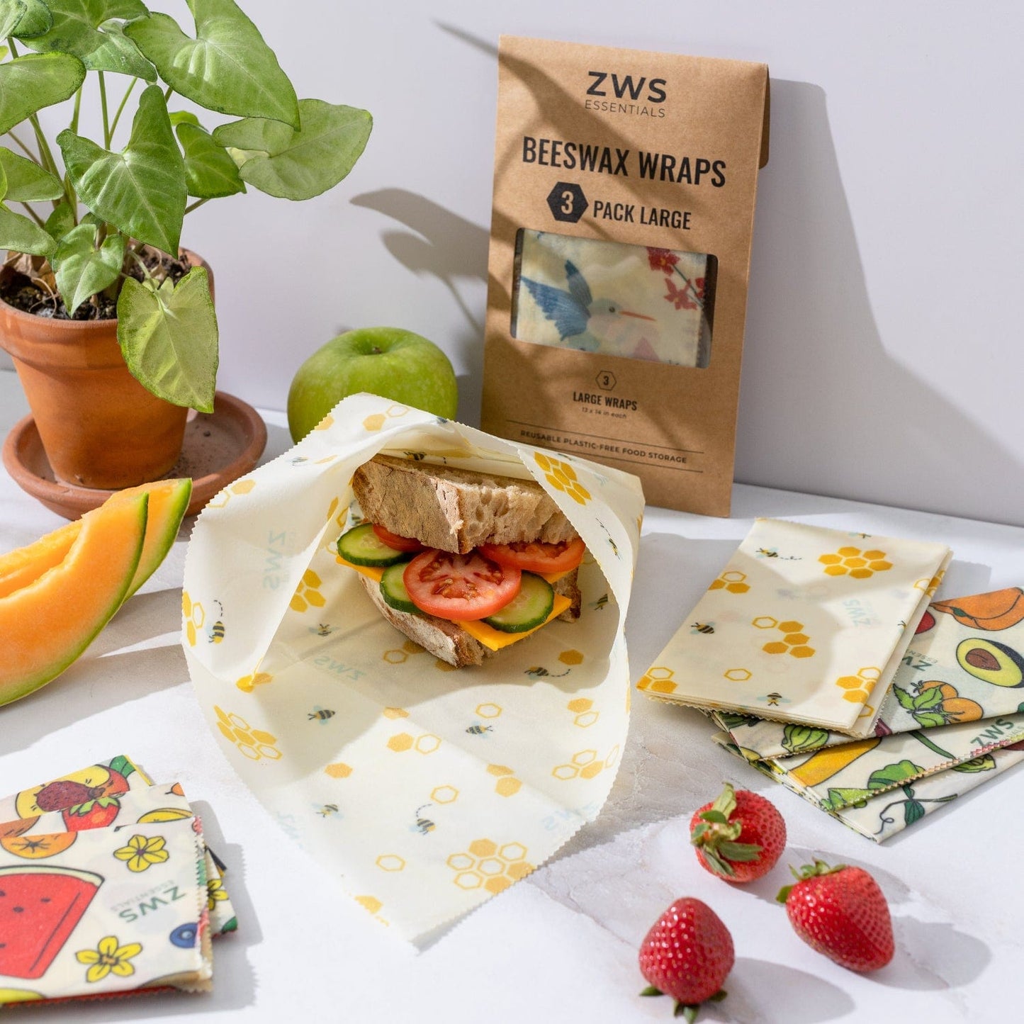 Beeswax wraps by ZeroWasteStore.com for plastic-free food storage, featuring colorful patterned fabric and beeswax coating.