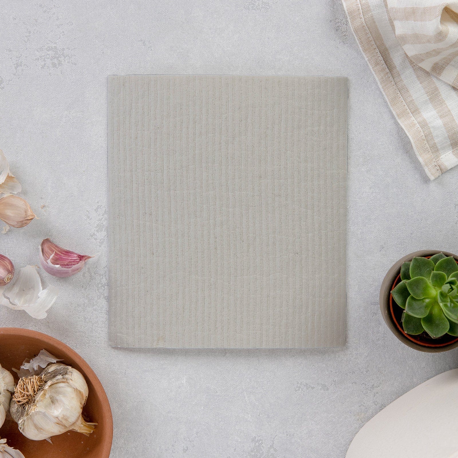 Gray Swedish dish cloth from ZeroWasteStore.com, reusable paper towel alternative, eco-friendly kitchen sponge for cleaning and drying.